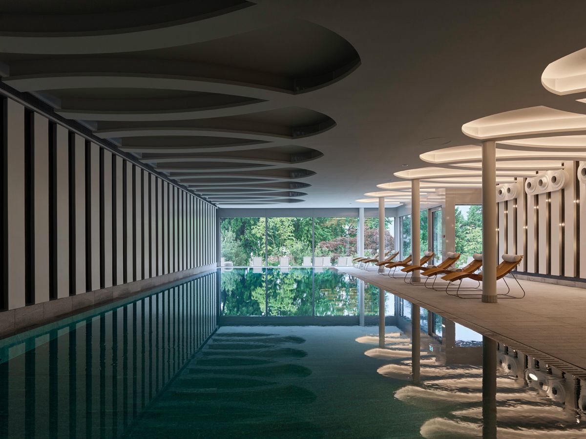 Stunning mirrored view of the poolside at the Chenot Palace Weggis