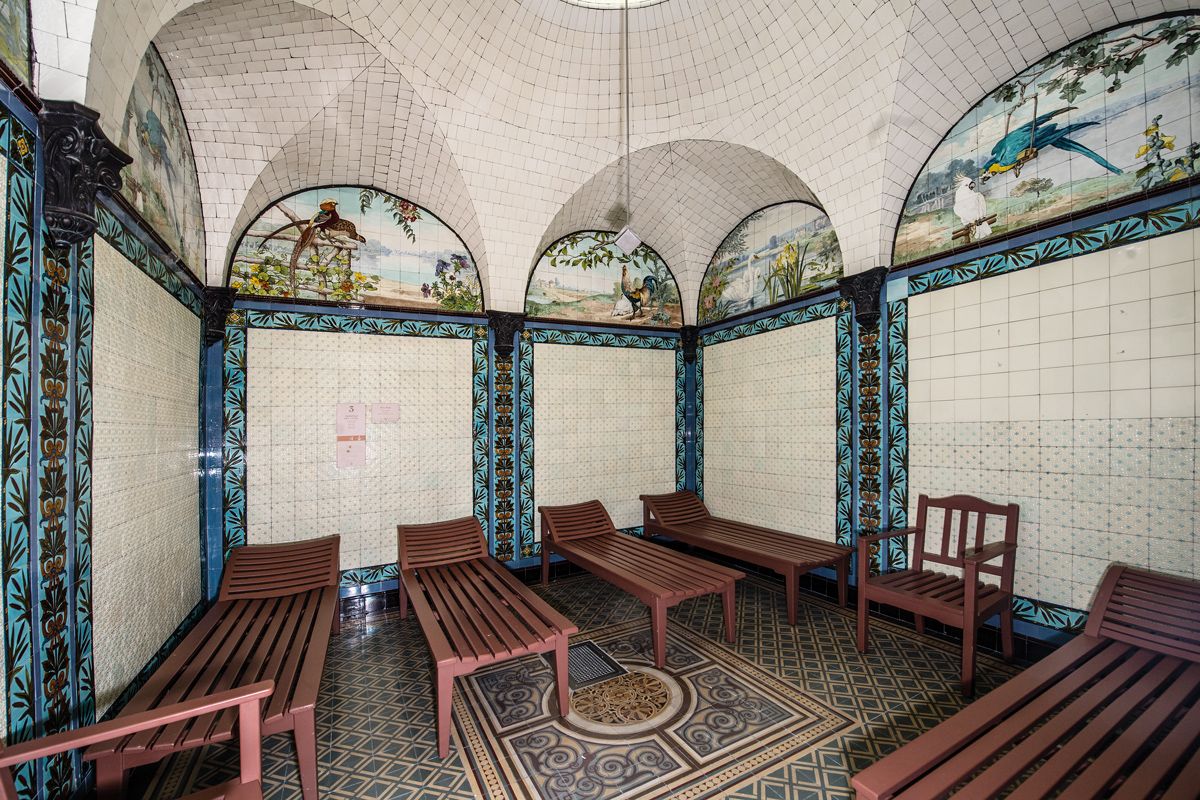 The treatment room at Friedrichsbad is dressed in eye-catching mosaic tiles