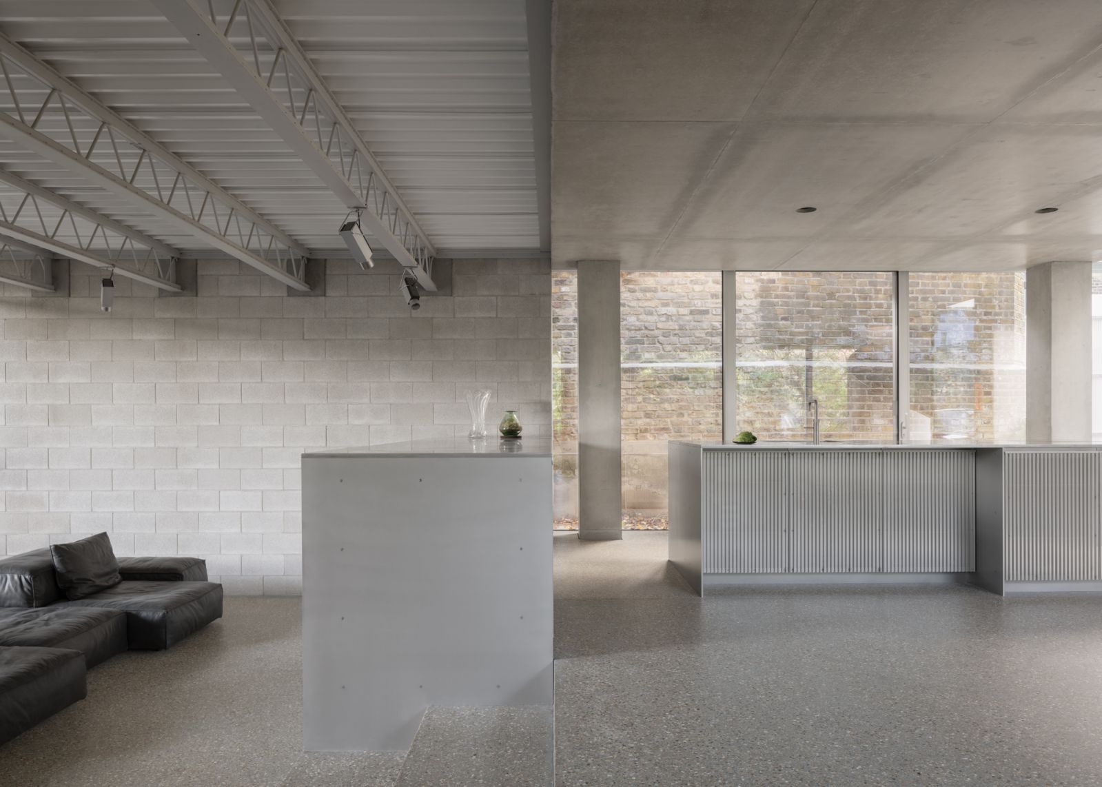 The kitchen is elevated, delineating it while maintaining an open connection with the other common areas