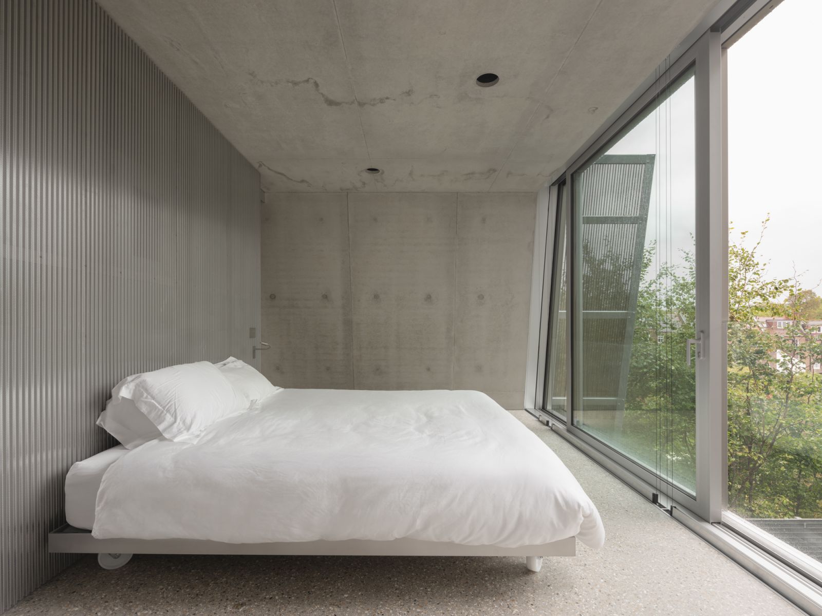 Like the rest of the home, the bedroom is kept minimal, making the brutalist architecture the highlight of the interiors