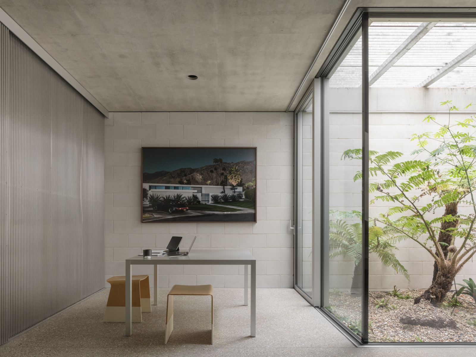 This intimate study offers a soothing view of an enclosed courtyard, bringing nature into the home while keeping the elements out