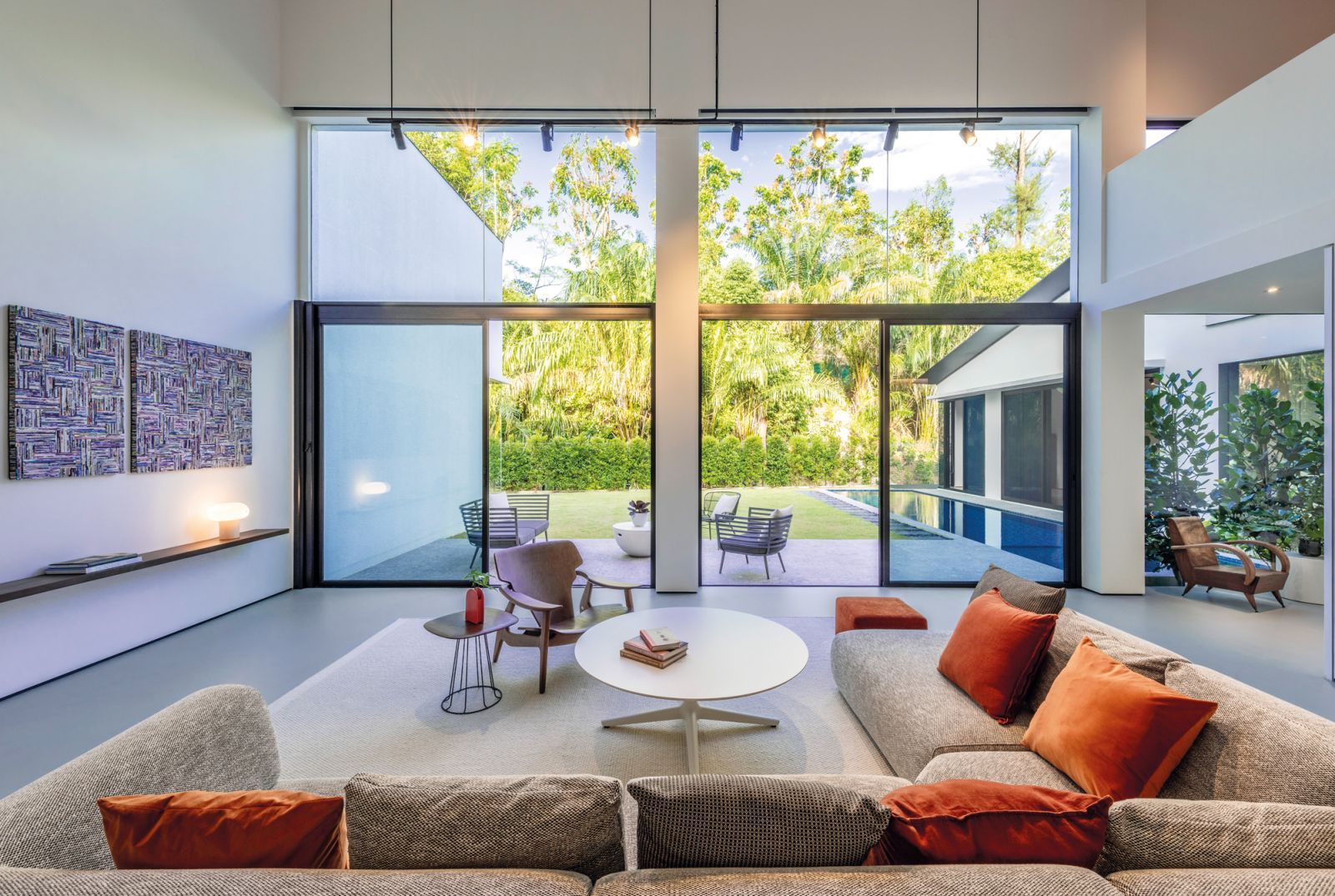 A patch of rainforest forms an organic backdrop to the living area