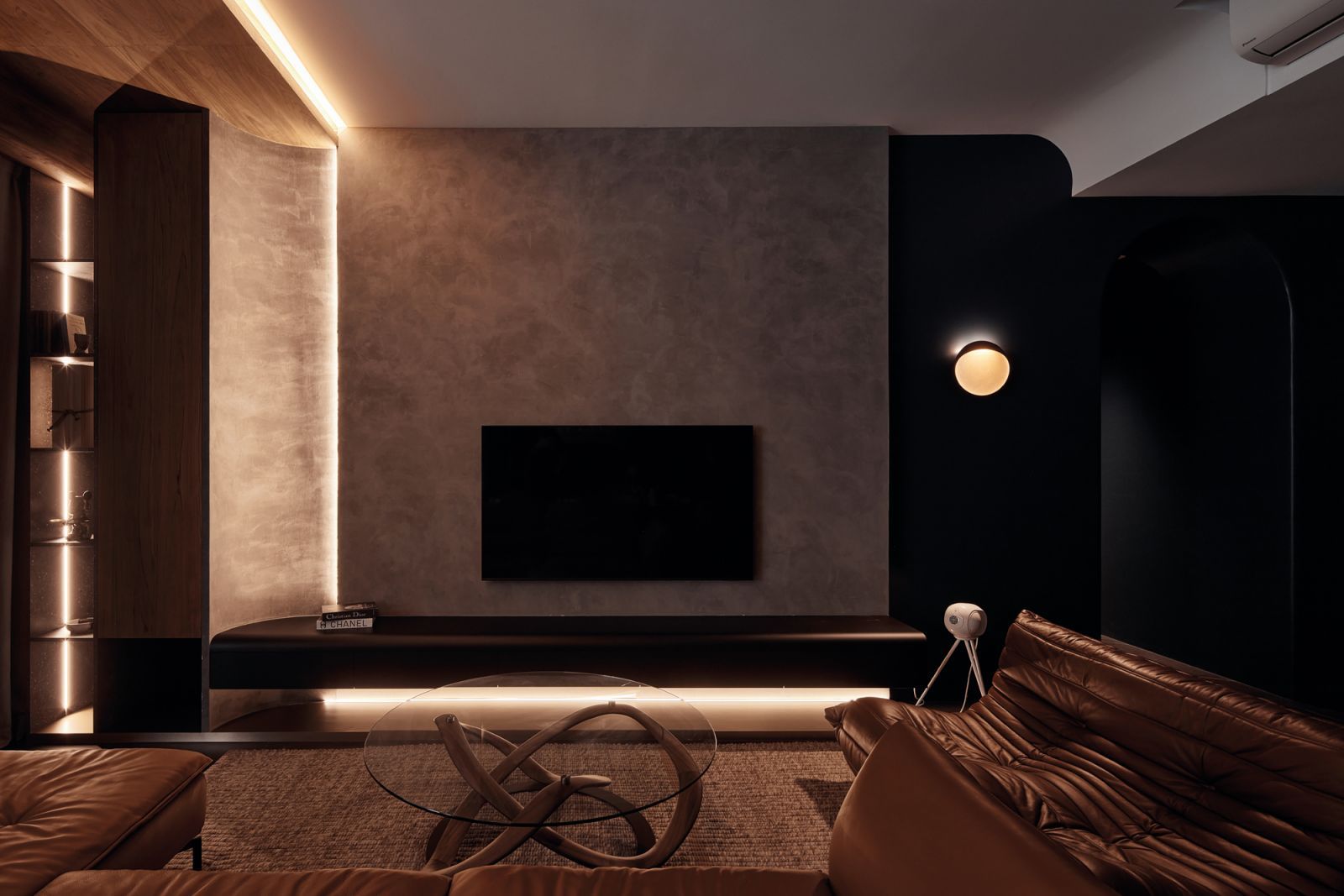 The living room in this home by Ethereall features various statement pieces, such as the Ligne Roset Togo sofa