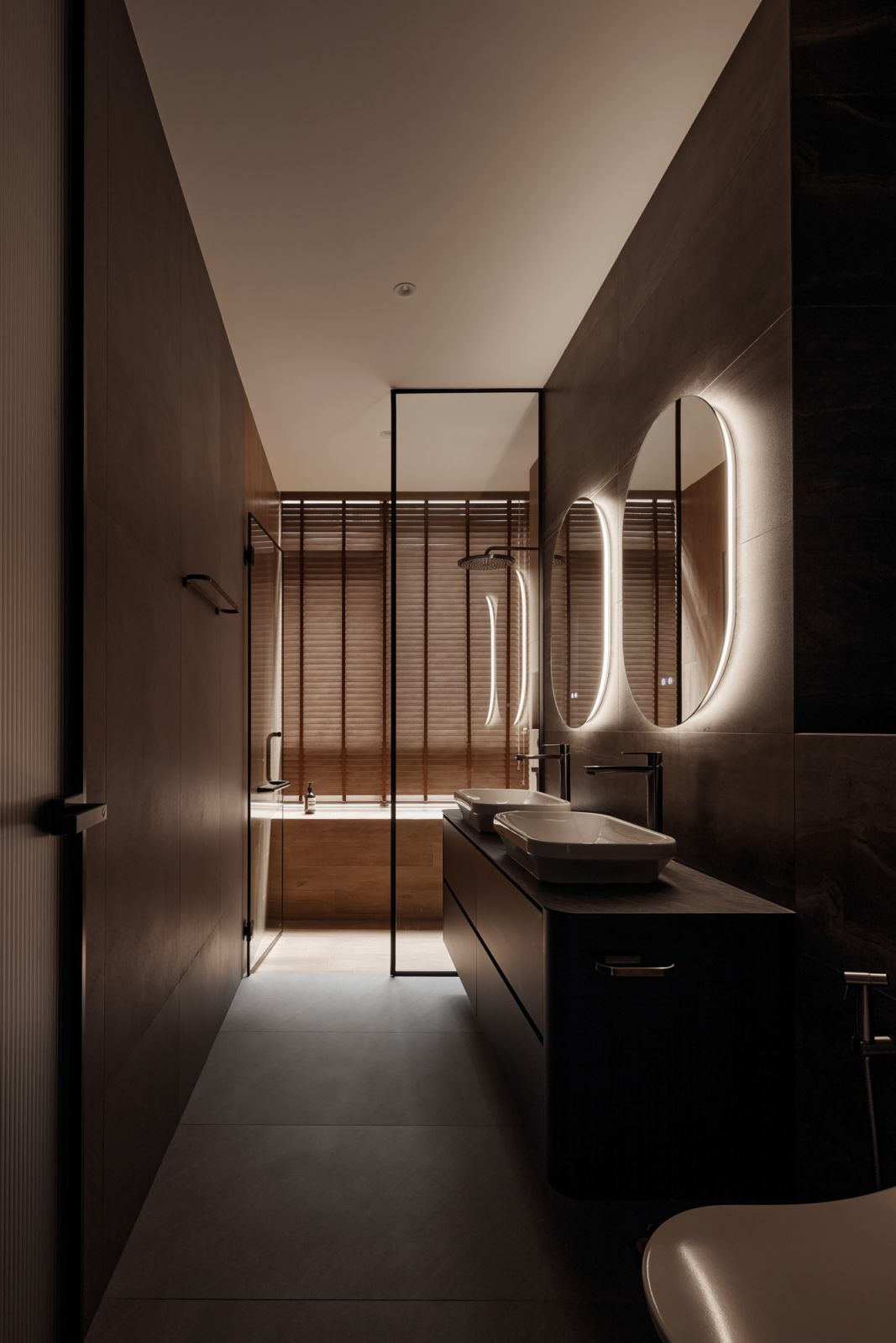 The master bathroom features his-and-hers washbasins
