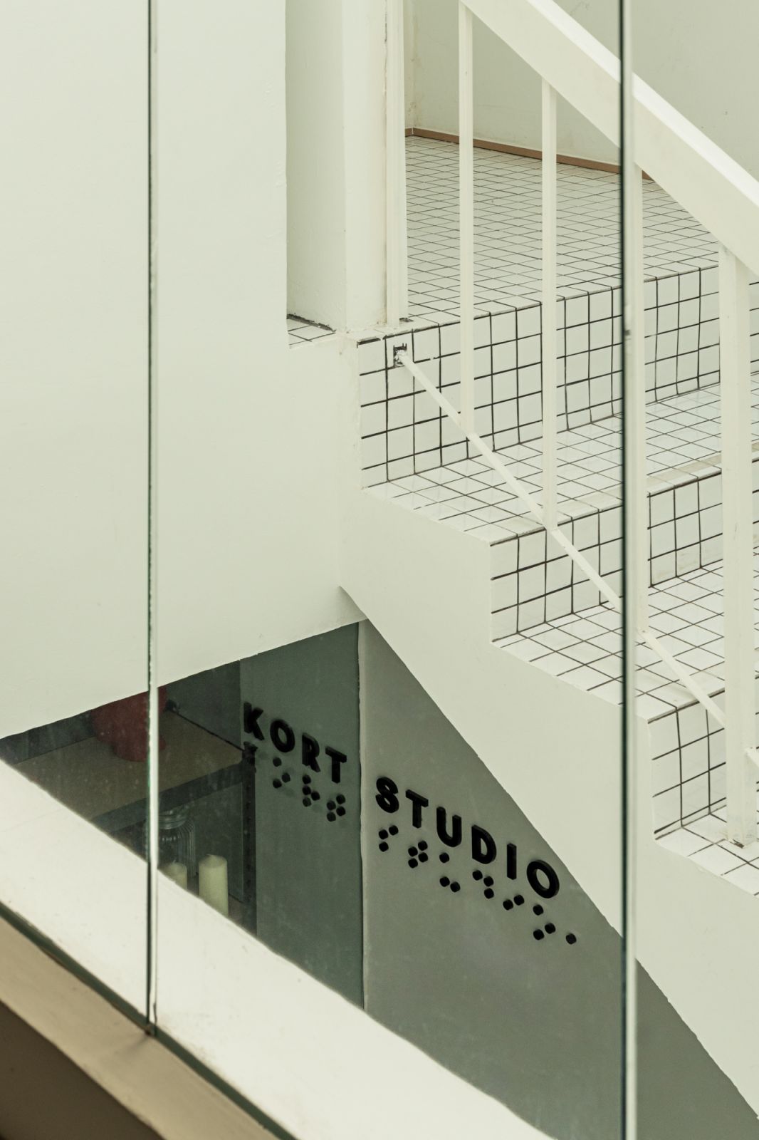 The studio signage showcases Kort Studio branding with minimalist typography and dotted pattern details