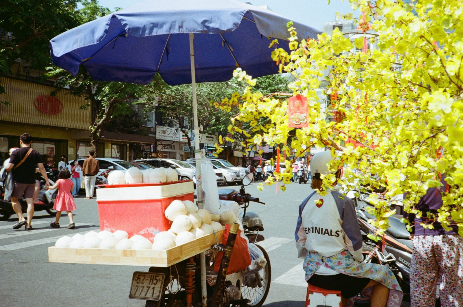 A parked motorcycle filled with coconuts for sale at the back. Ho Chi Minh City, 2025 (Photo: Jove Moya)