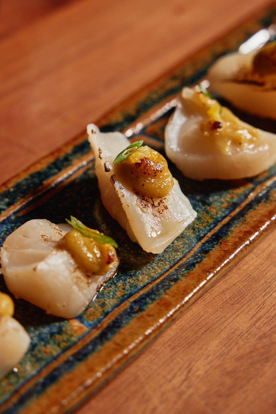 Abrí Japanese scallop with yuzu miso infused with Martell VSOP by Kei Maki | Photo by JV Rabano