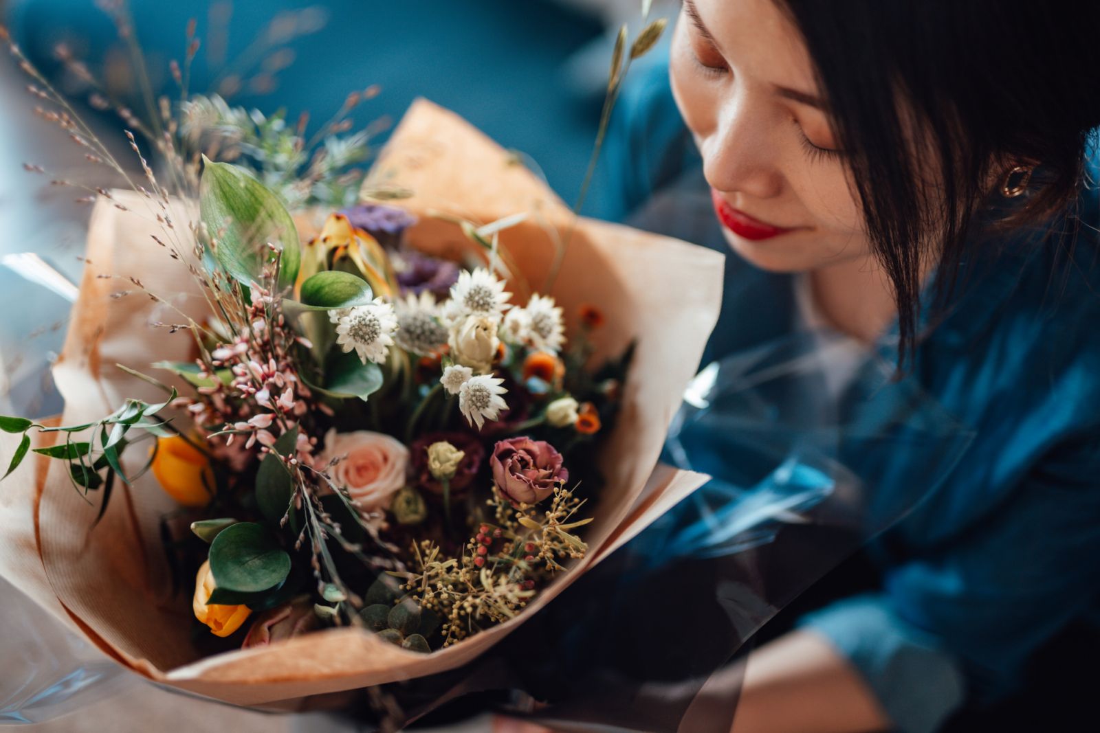 Aerial view of young woman receiving flower bouquet delivery on Valentine’s day. Online dating concept. Long distance relationship concept. Remote love.