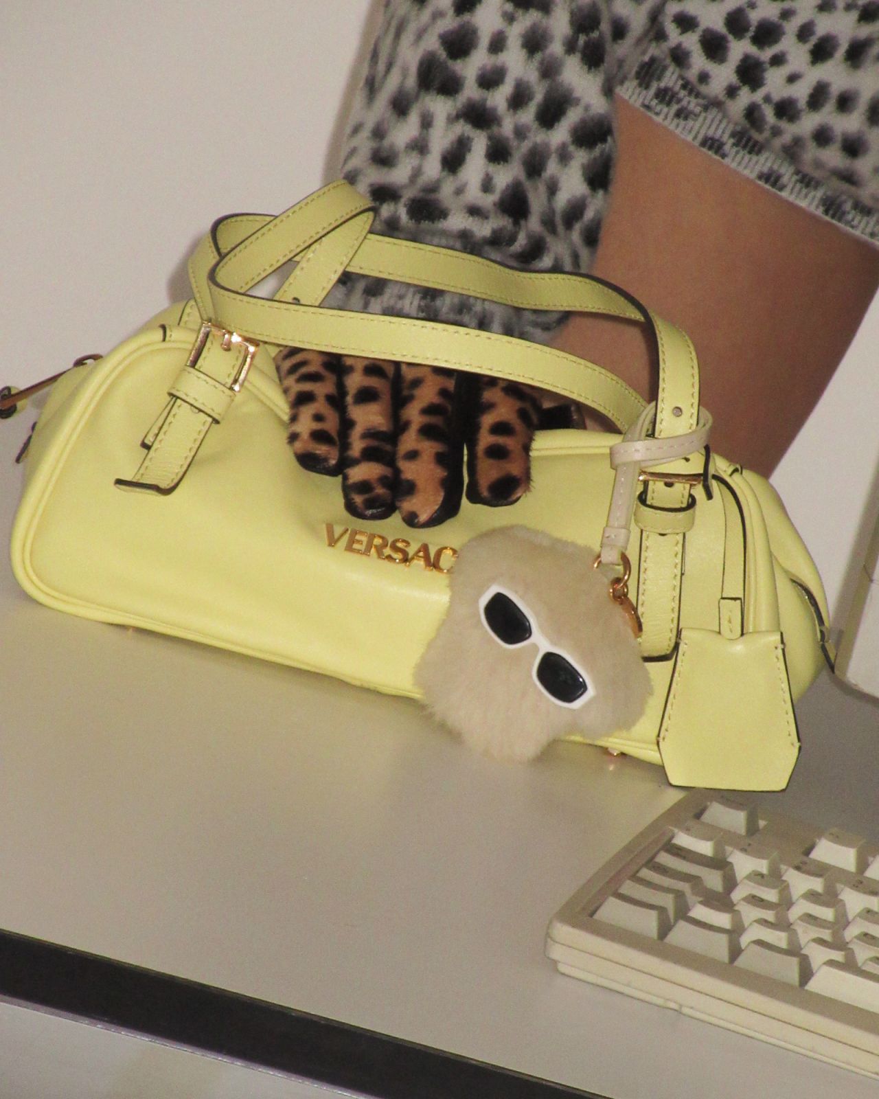 The Versace Tag Bag in Pale Yellow with the Medusa Fluffy charm (Photo: Versace)