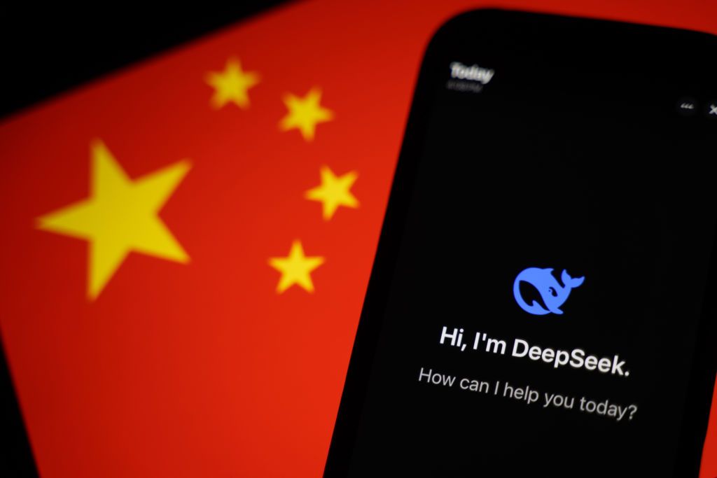 HONG KONG, CHINA - JANUARY 28: In this photo illustration, the DeepSeek apps is seen on a phone in front of a flag of China on January 28, 2025 in Hong Kong, China. Global tech stocks have plummeted following the emergence of DeepSeek, a Chinese AI startup that has developed a competitive AI model at a fraction of the cost of its US rivals, sparking concerns about the high valuations of tech giants like Nvidia. This development has led to significant declines in tech shares across Asia and Europe, with mark