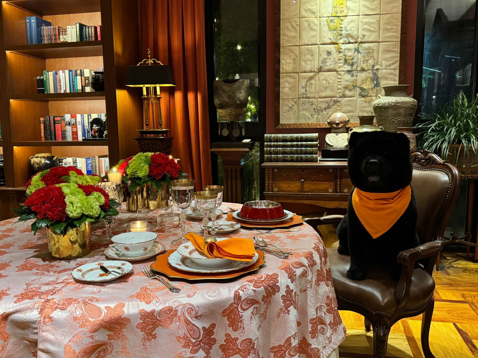 Joker Arroyo's Valentine's Day tablescape, featuring Rex the Chow Chow alongside orange Meissen porcelain and tasteful silverware