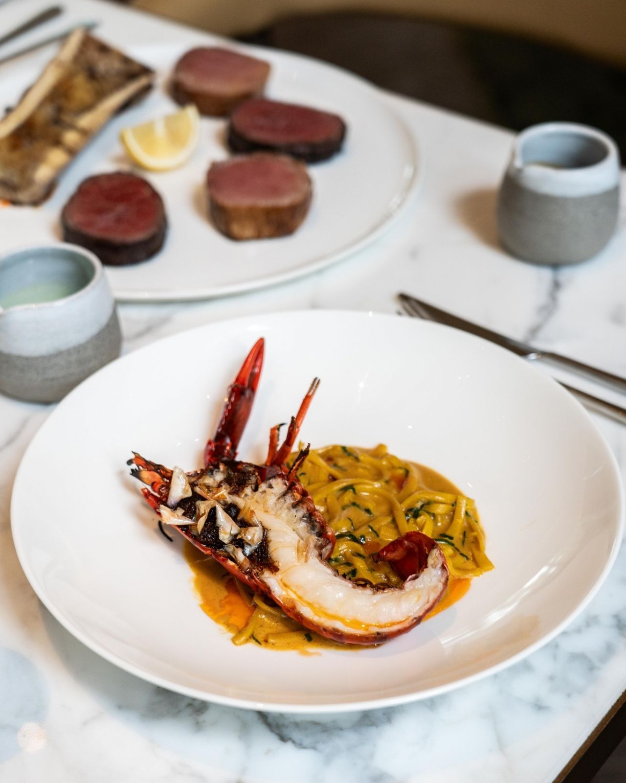 Grilled Australian crayfish and fish bone noodles with scallop XO butter (Photo: Facebook/ Fysh Singapore)
