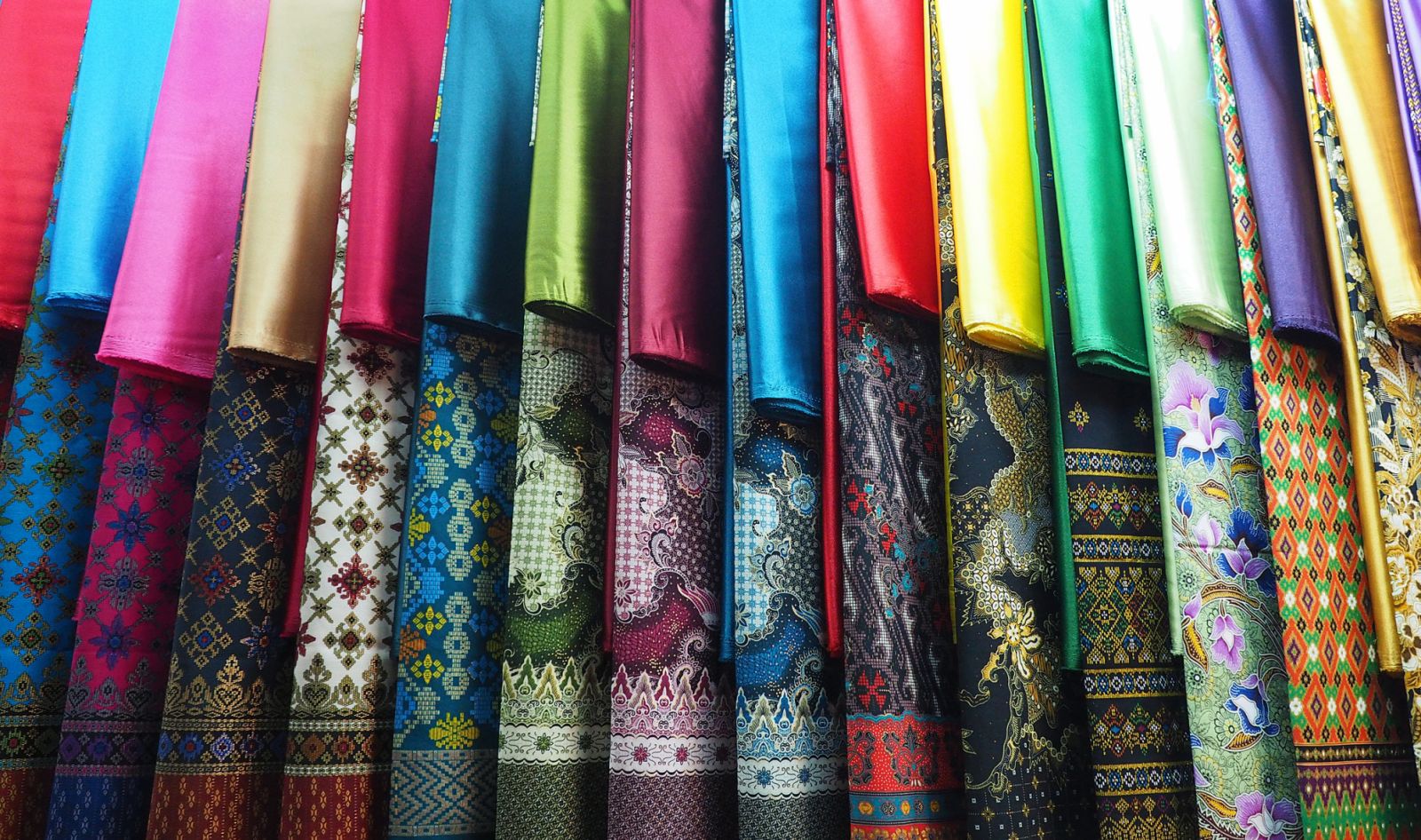 row of colorful set Kebaya skirt dress in local market display
