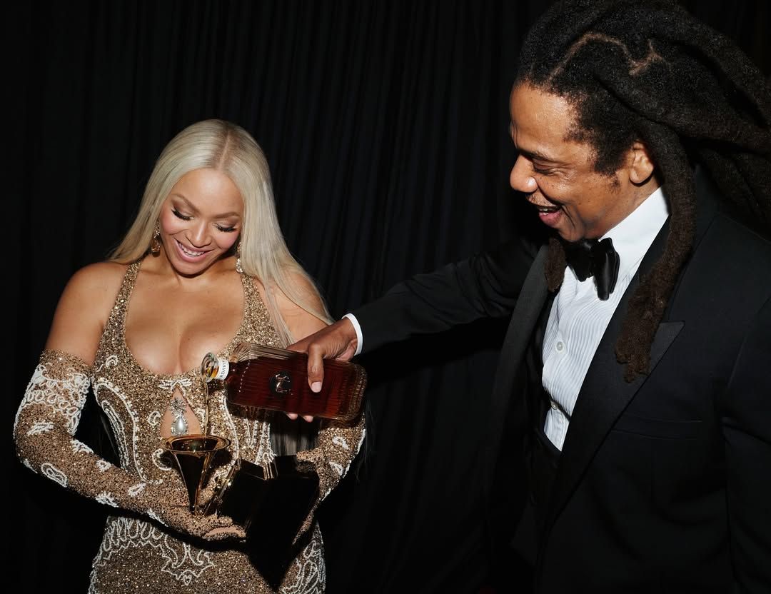Beyonce and Jay-Z pouring whiskey