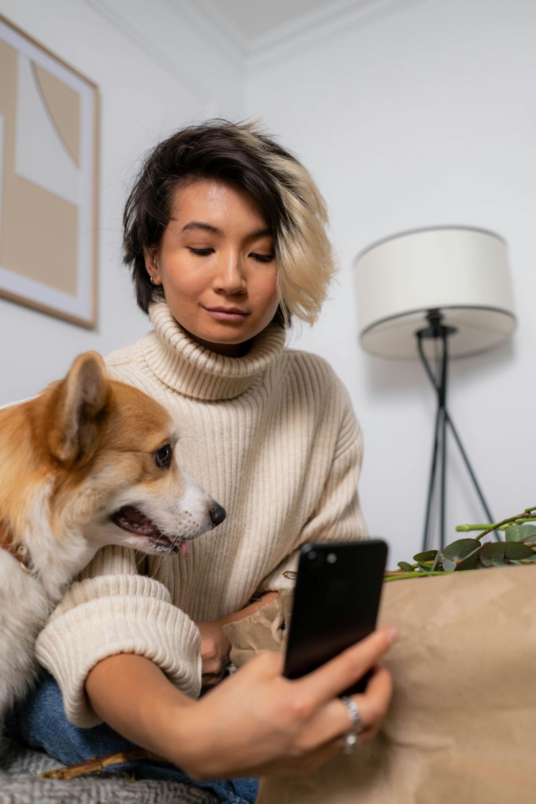 Woman taking photo with dog