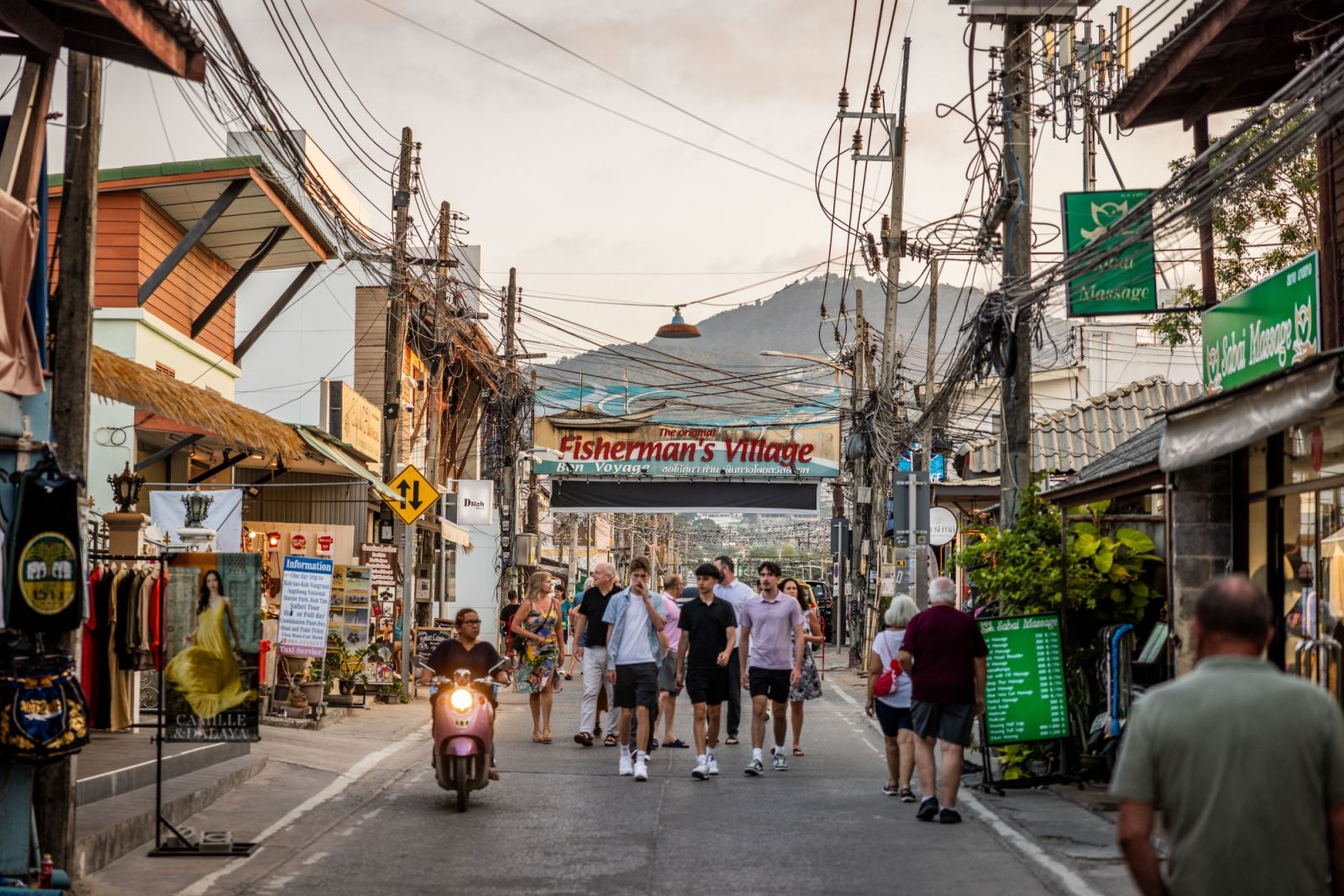 KOH SAMUI, THAILAND - MARCH 23: Tourists enter the Fisherman's Village walking street night market on March 23, 2024 in Koh Samui, Thailand. The upcoming season of "The White Lotus" is anticipated to have a massive impact on tourism in Thailand, with travel forecasters predicting a surge in visitors to destinations like Koh Samui, Phuket, and Bangkok. The allure of experiencing the real-life locations featured in the series is expected to fuel a travel trend, drawing attention to Thailand as a top-tier buck