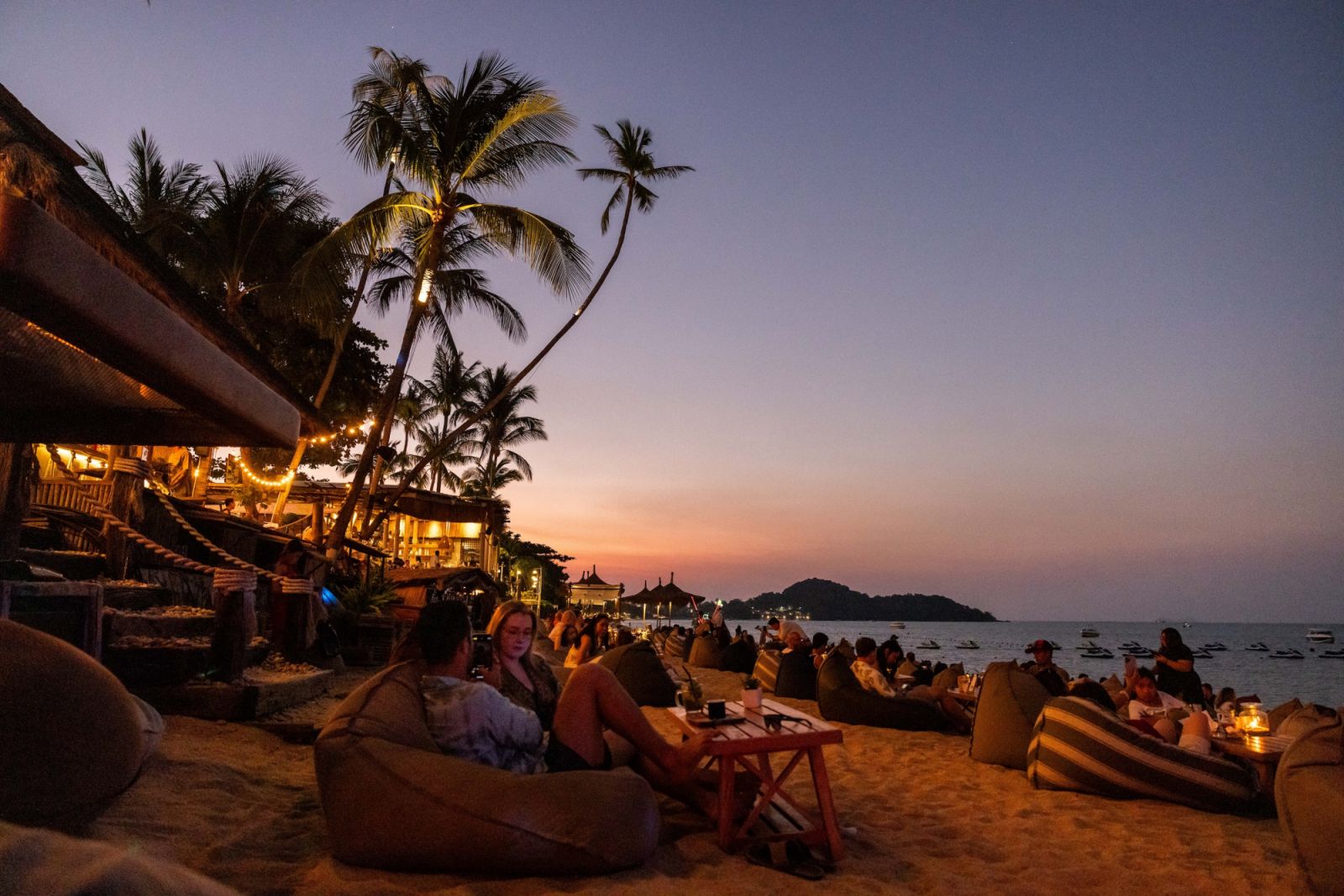 KOH SAMUI, THAILAND - MARCH 23: Tourists watch the sunset from Coco Tam's beachside restaurant on Bo Phut Beach on March 23, 2024 in Koh Samui, Thailand. The upcoming season of "The White Lotus" is anticipated to have a massive impact on tourism in Thailand, with travel forecasters predicting a surge in visitors to destinations like Koh Samui, Phuket, and Bangkok. The allure of experiencing the real-life locations featured in the series is expected to fuel a travel trend, drawing attention to Thailand as a