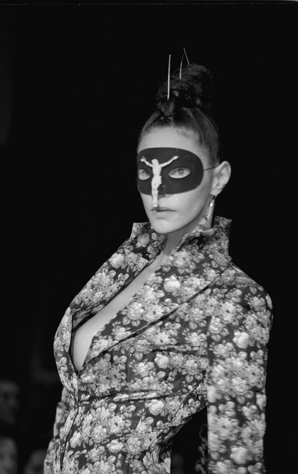 Model wearing a crucifix mask walks the runway at Alexander McQueen's first New York fashion show in 1996 (Photo: Getty Images)