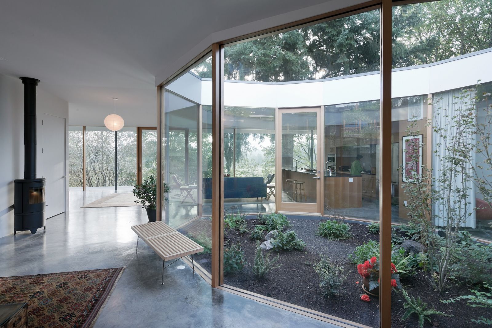 The glass courtyard of this family sanctuary in Oregon, designed by No Architecture