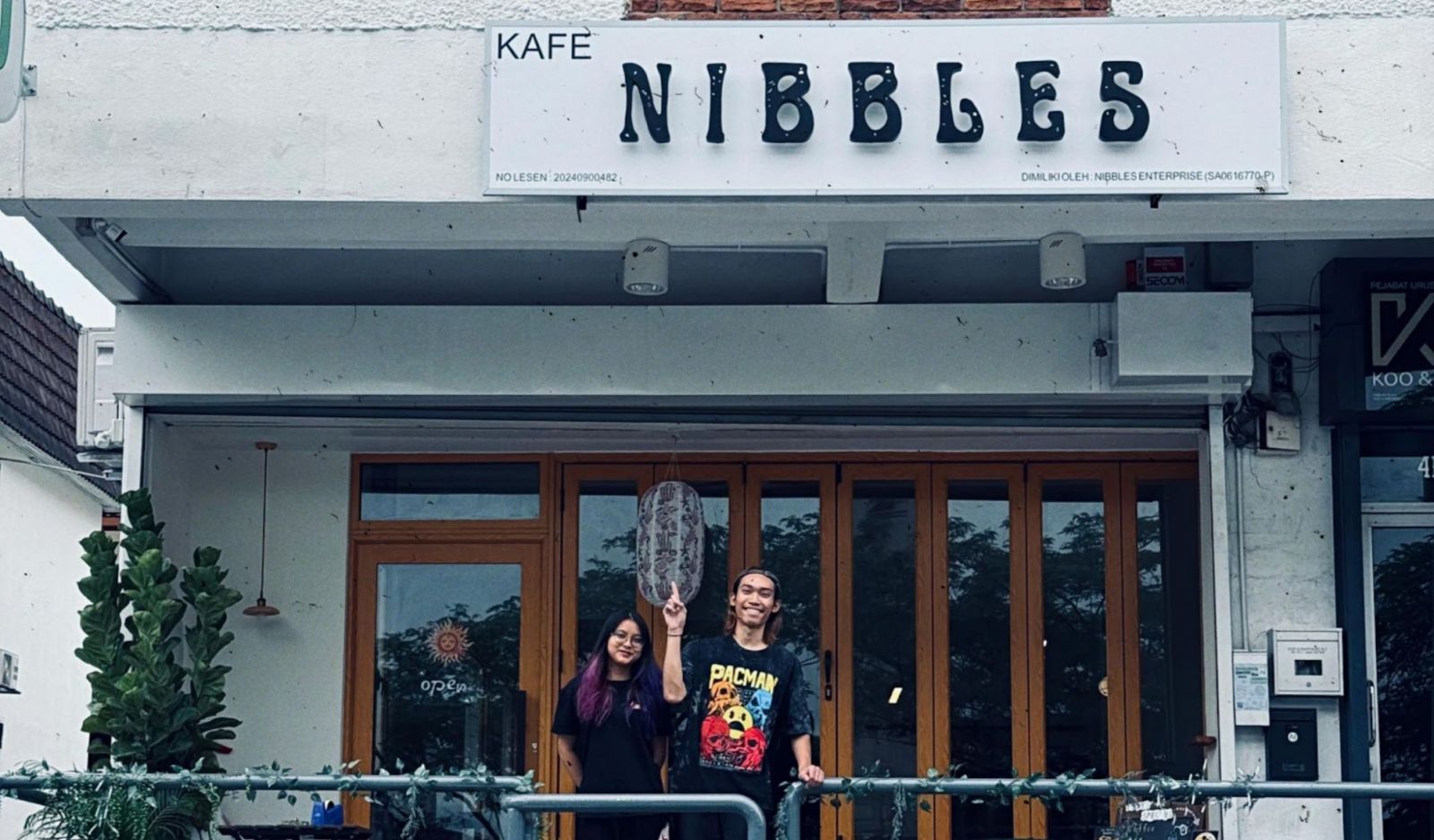 Wan Muhammad Bin Wan Sa’adi and fellow founder, Mysara Elysha, standing in front of Nibbles Café, the Sarawakian-inspired café in SS18 that promotes healthy living and mental health awareness