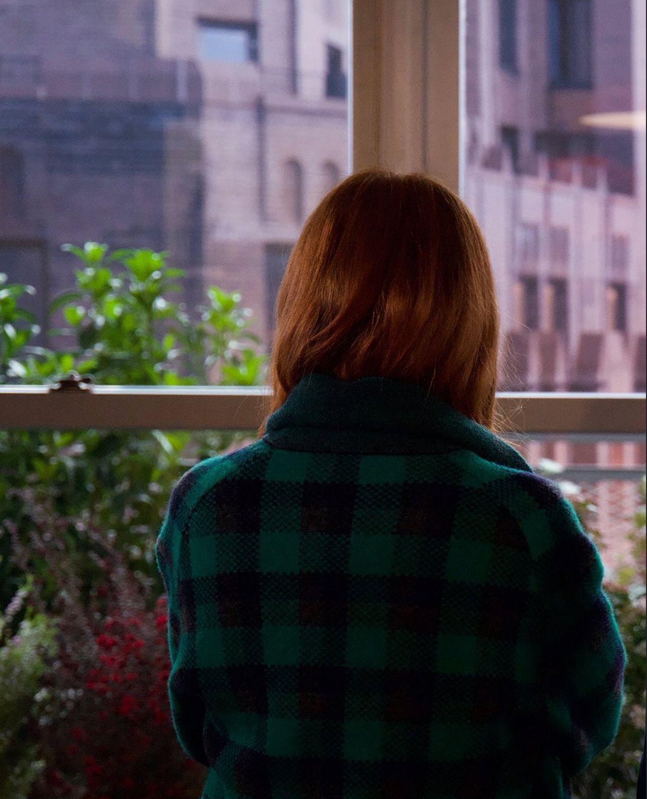 Julianne Moore as Ingrid looking out the window of Tilda Swinton's apartment (Photo: The Room Next Door / Instagram)