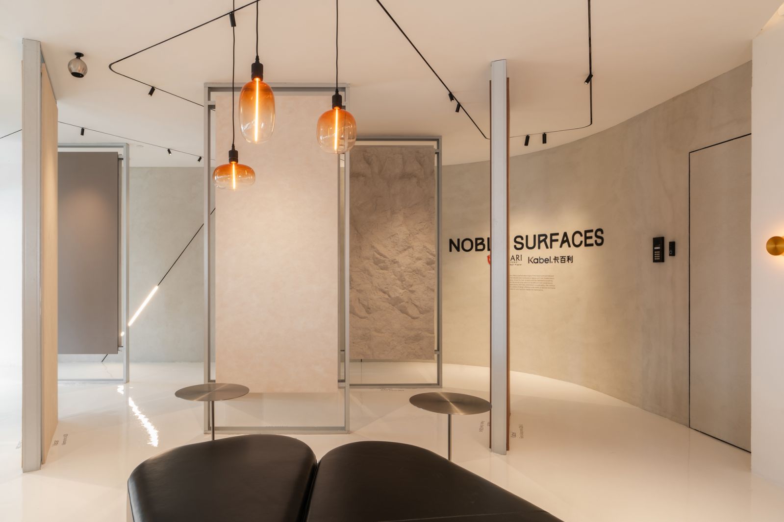 A space inside the showroom dedicated to Noble Surfaces, featuring the Circuit.11 lighting series along the ceiling
