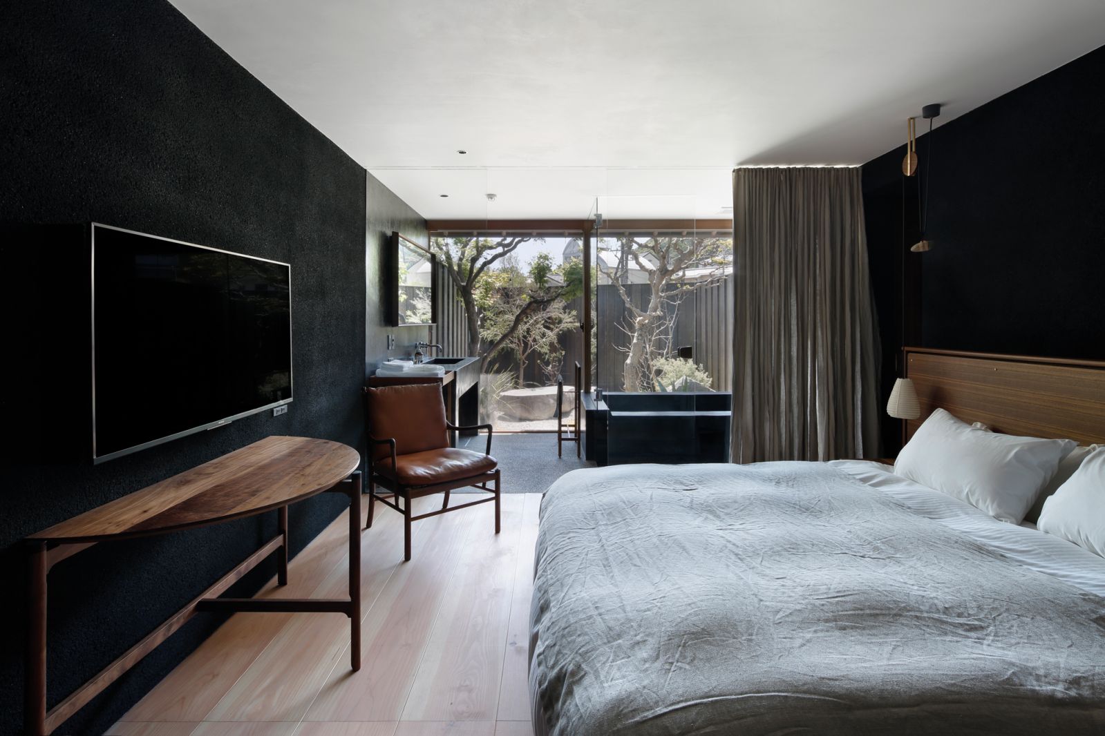 Each room at Arashiyama House Mama is furnished with handcrafted pieces by Kyoto artisans as well as stone baths looking into private gardens