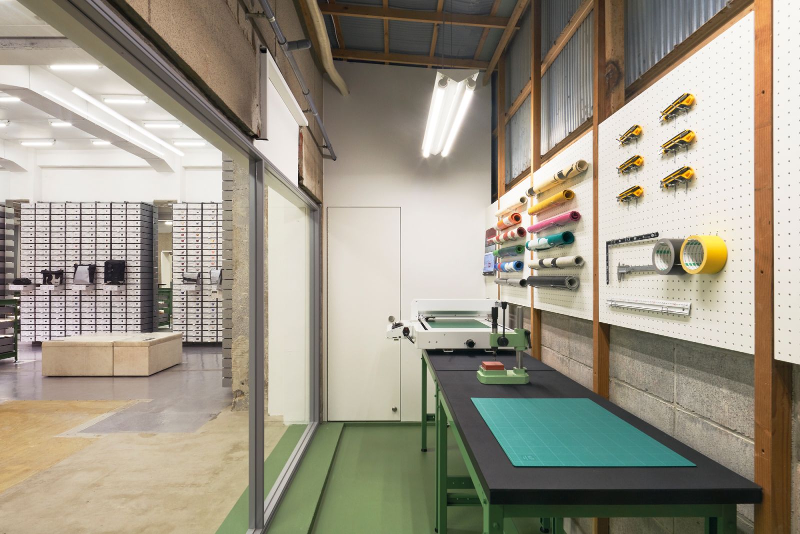 A workstation for customers to have a go at using tarpaulin offcuts to customise small accessories in the Freitag Kyoto store