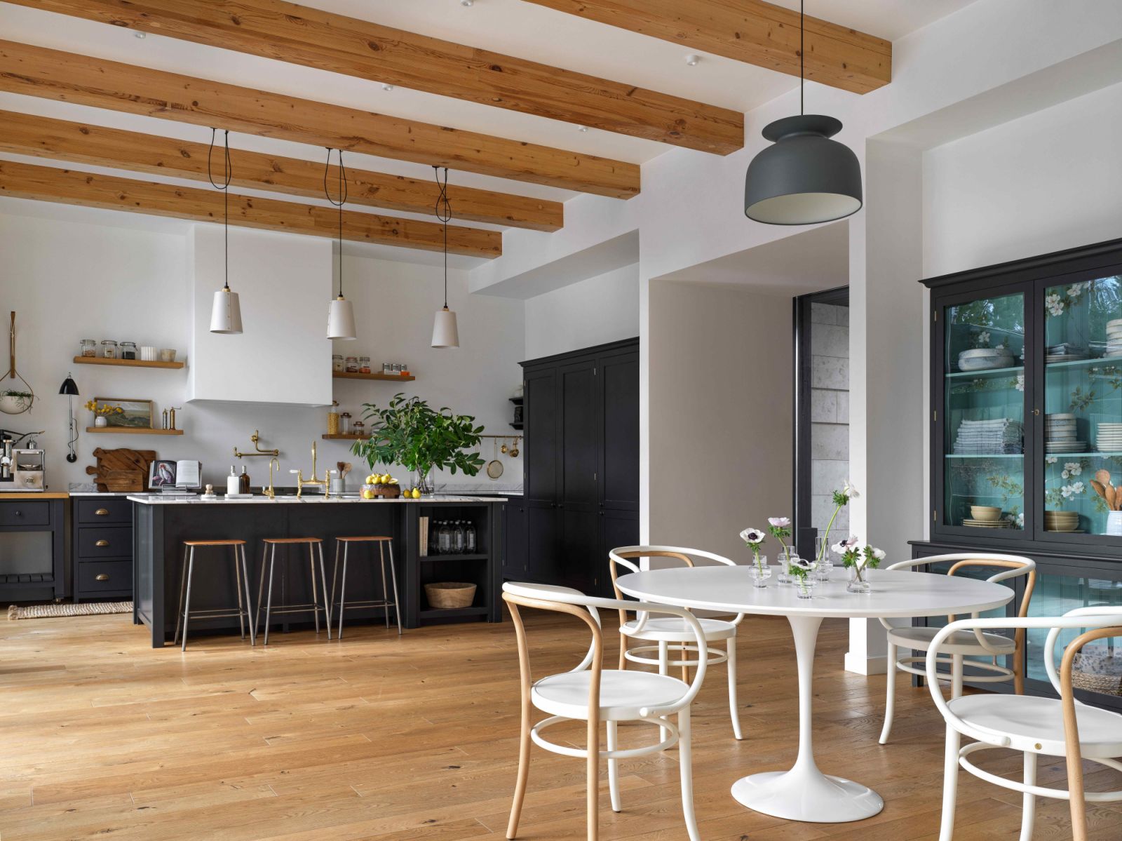 The open space with an intimate breakfast nook and hand-painted cabinets