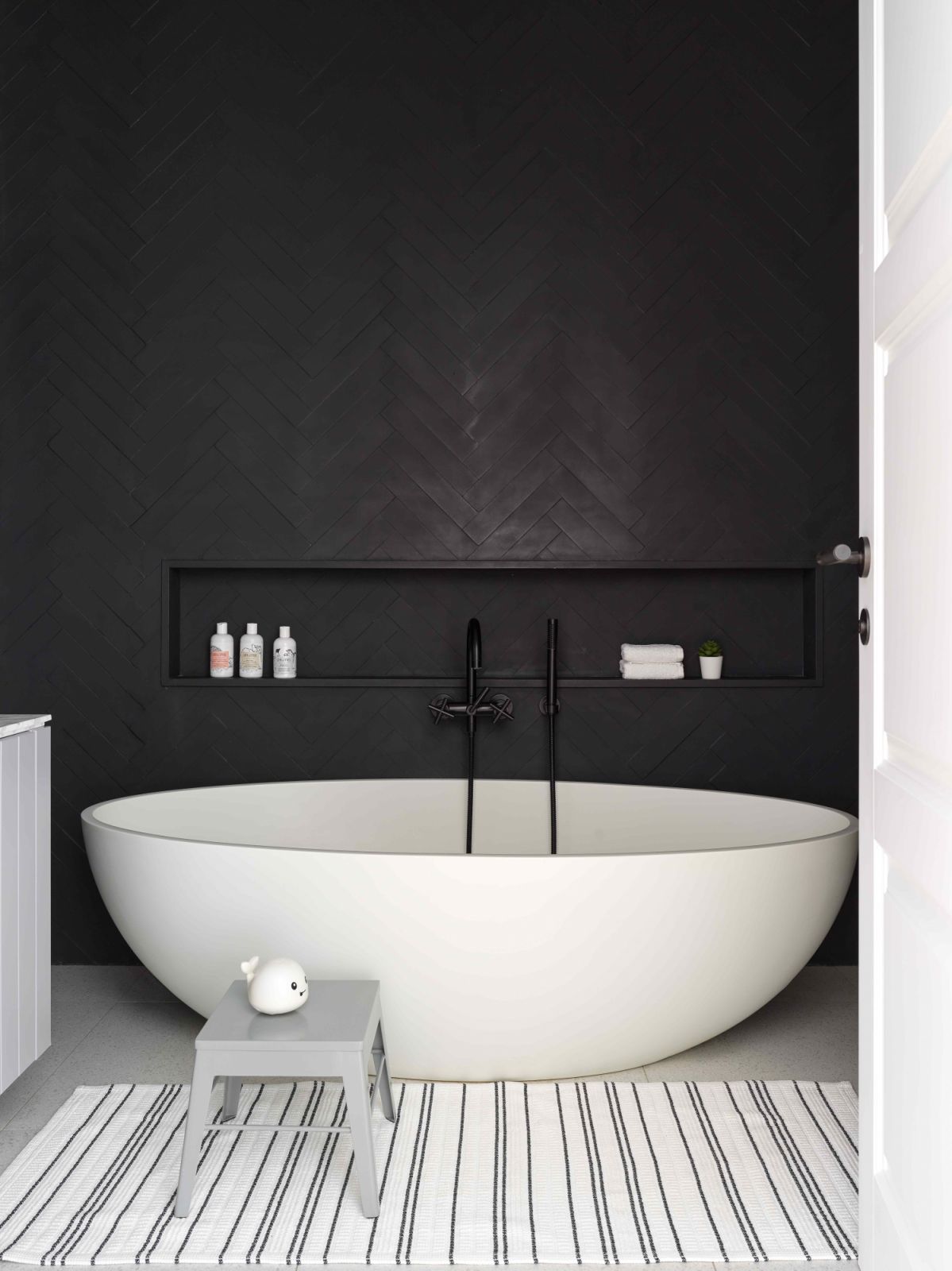 Subtle herringbone patterns in the children’s bathroom