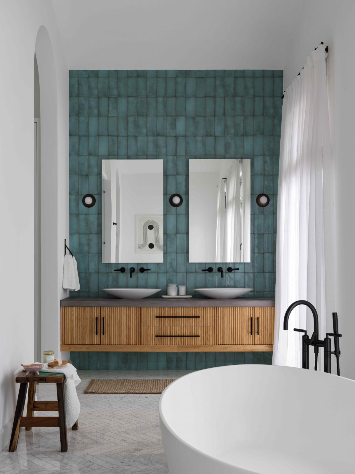 Deeper green tiles and fluted plaster in warm wood tones