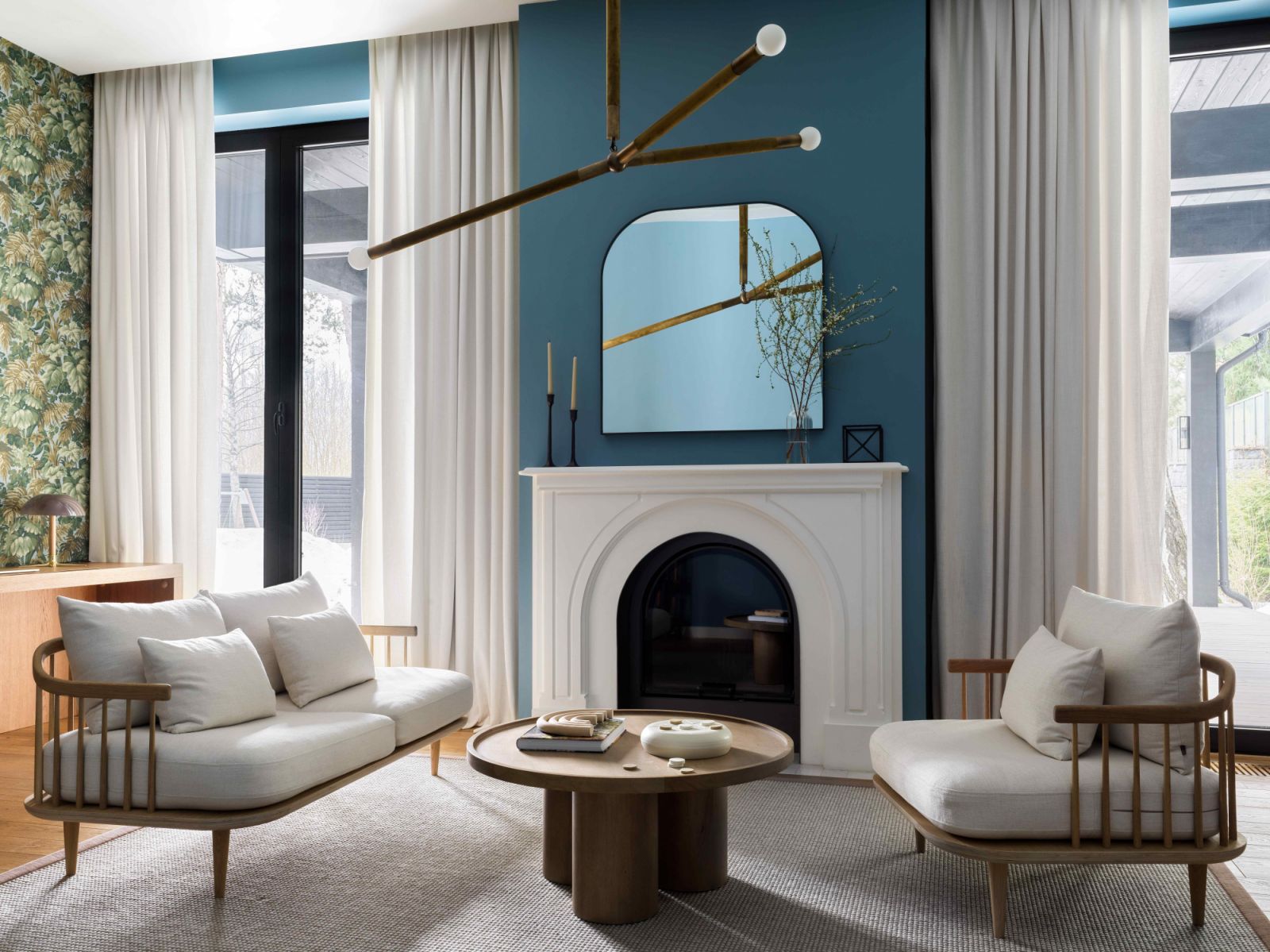 A blue-walled plaster fireplace in the office-slash-guest-room