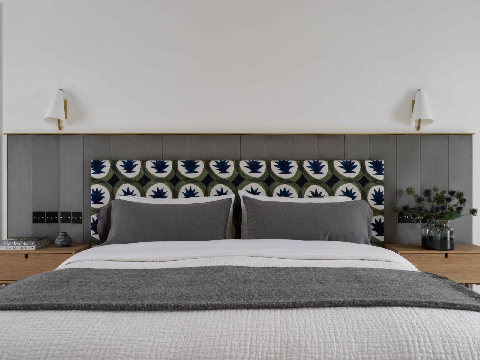 The sage green headboard, custom-made by Hermès, in the main bedroom suite