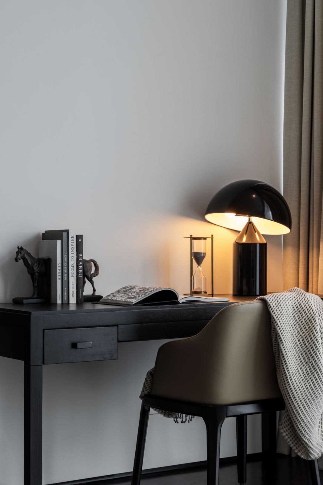 A thoughtfully designed work area incorporates brass accents and dark wood elements