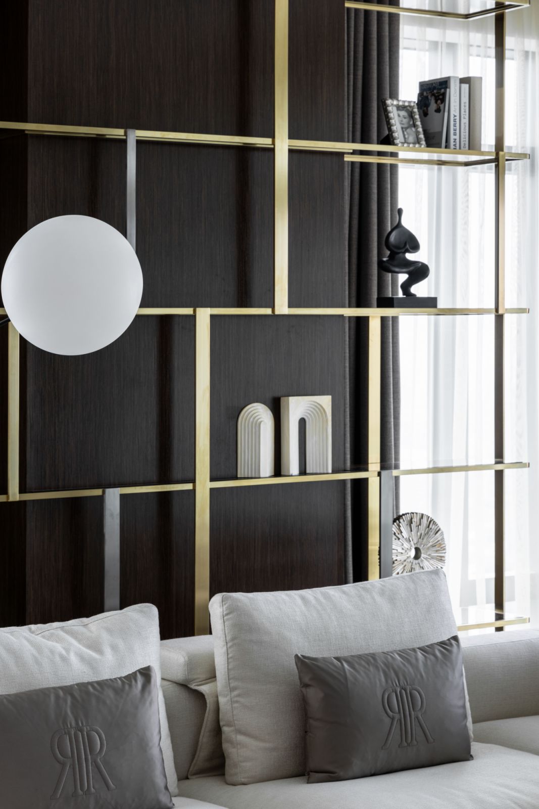 Custom shelving with brass inlays echoes Manhattan’s architectural aesthetic