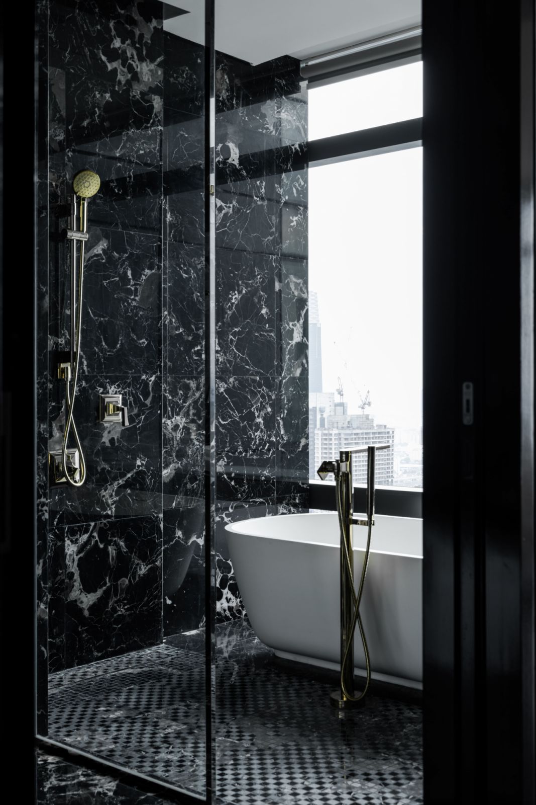 Floor-to-ceiling dark marble elevates this private retreat