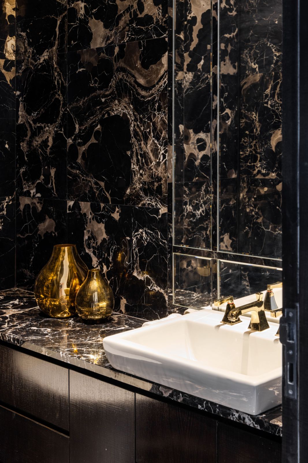 Dark marble wall cladding creates a dramatic spa-like sanctuary