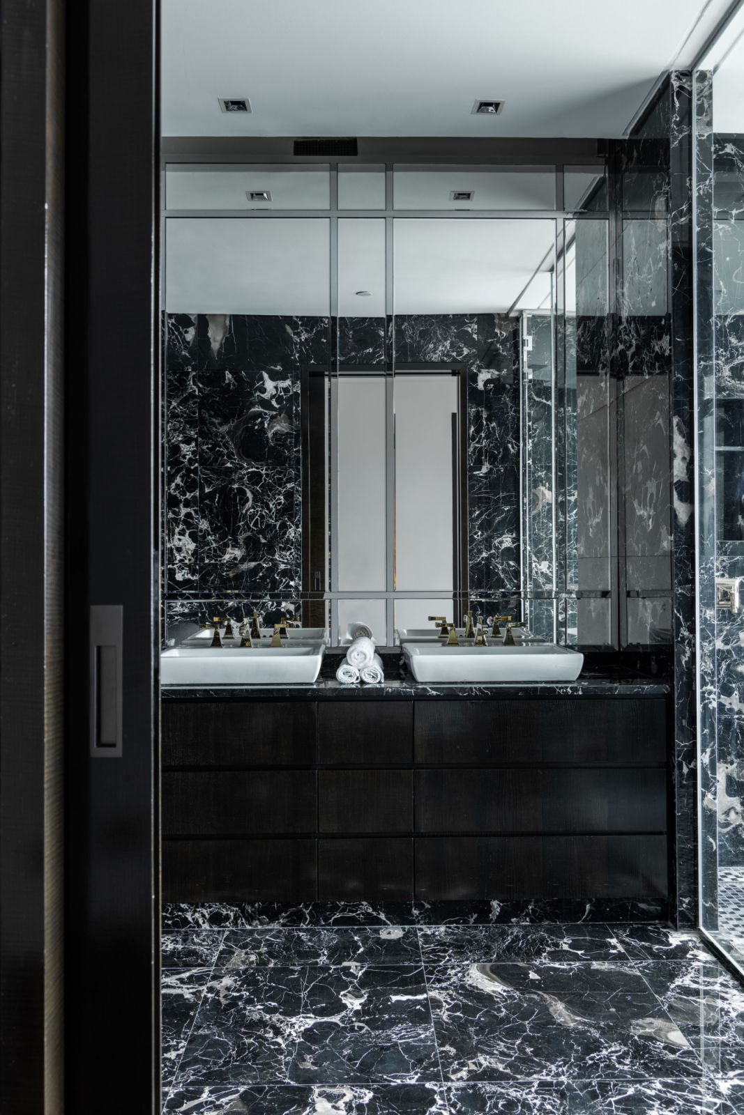 Floor-to-ceiling dark marble elevates this private retreat