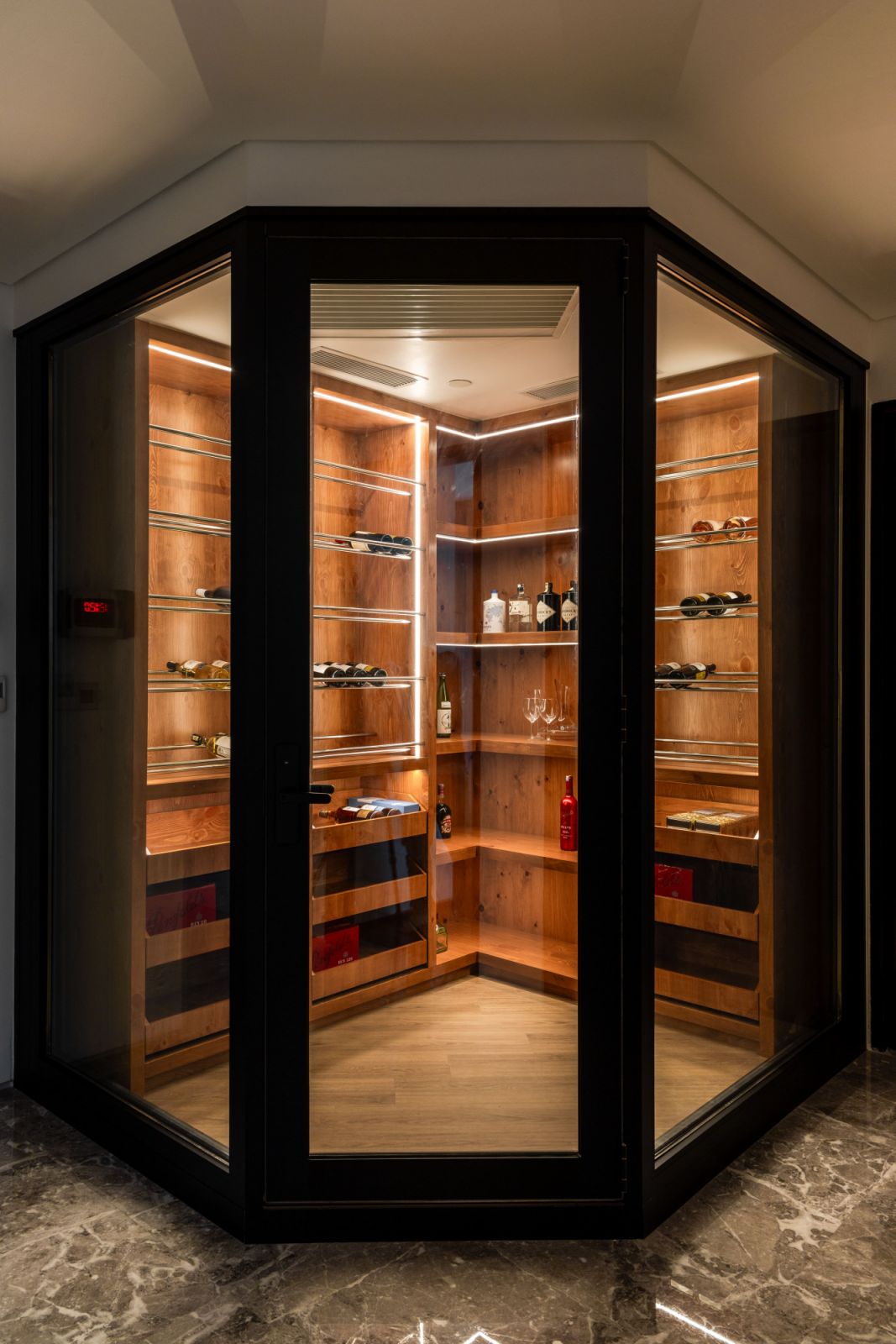 Custom-built climate-controlled storage marries form and function in this dedicated wine and spirit room