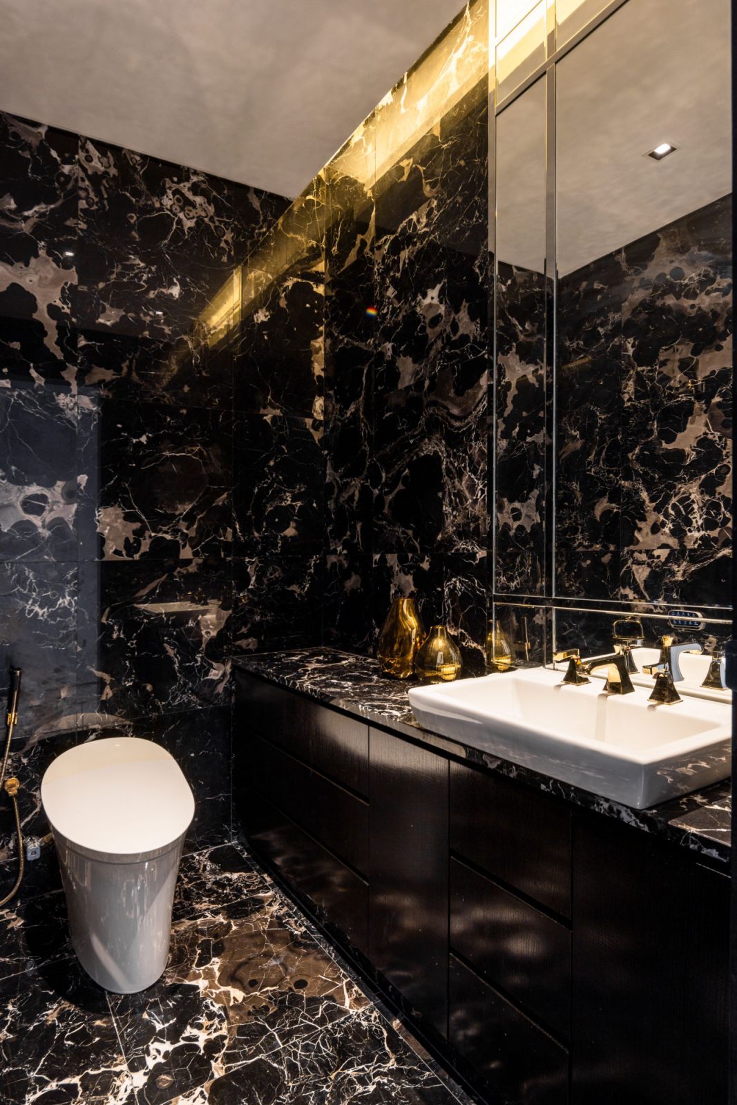 Dark marble wall cladding creates a dramatic spa-like sanctuary