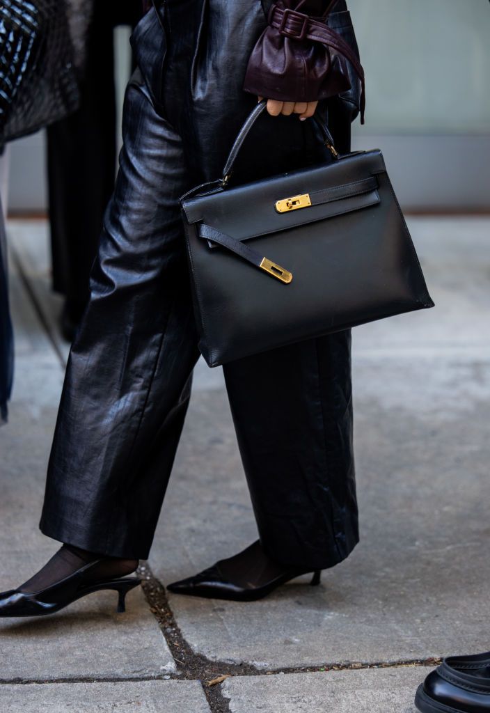 NEW YORK, NEW YORK - FEBRUARY 07: A guest wears black Hermes bag, leather pants outside Lafayette 148 on February 07, 2025 in New York City. (Photo by Christian Vierig/Getty Images)