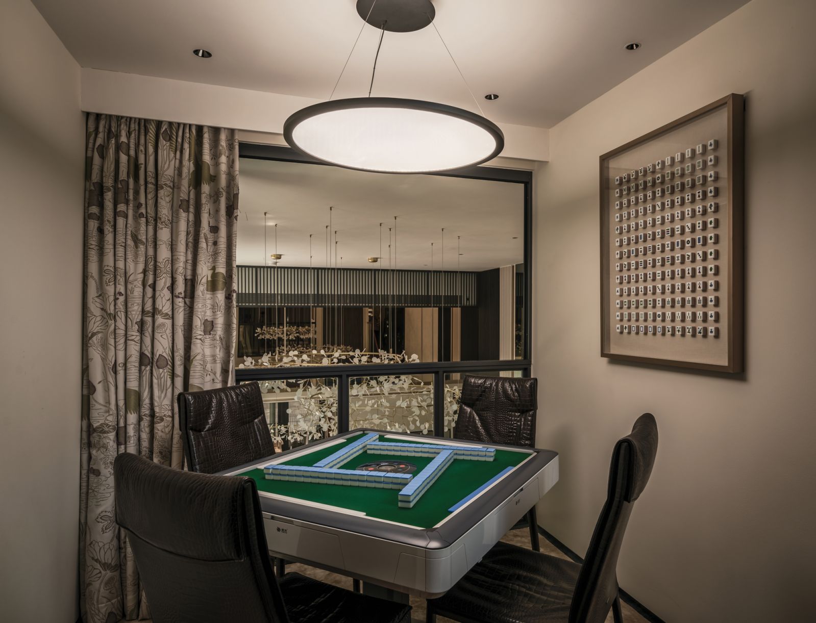 This mahjong table dominates the mezzanine’s cantilevered zone, which also boasts sweeping views of the ground floor