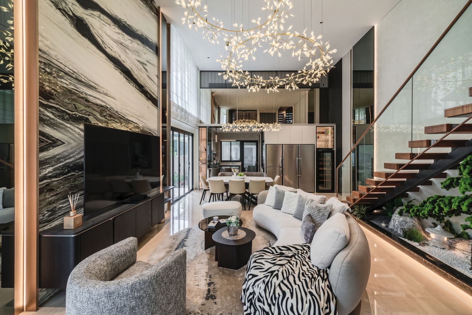 The airy living space features a 5.2m-high ceiling and a slew of biophilic design elements