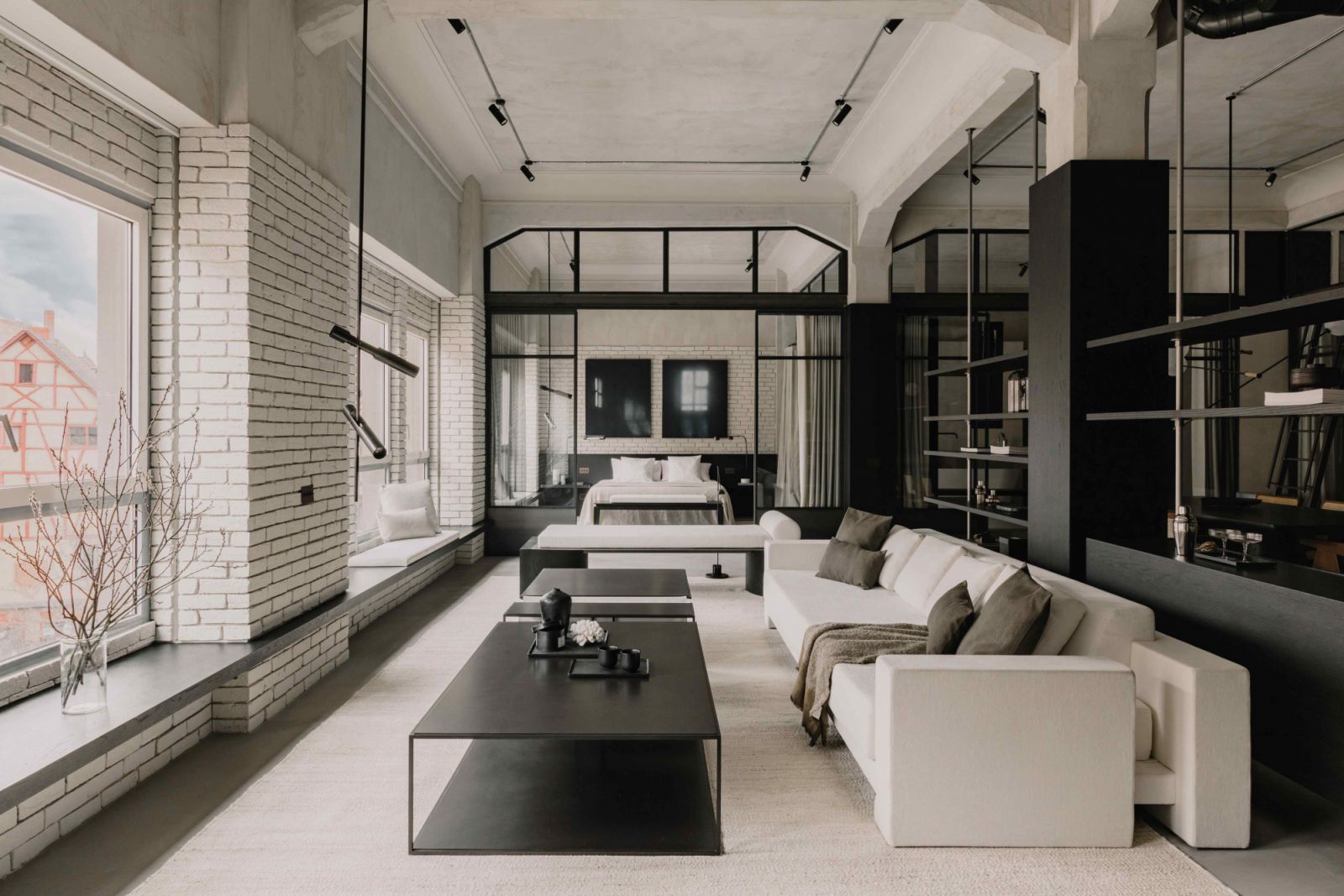 The open-concept apartment welcomes natural light into every area of the minimalist space
