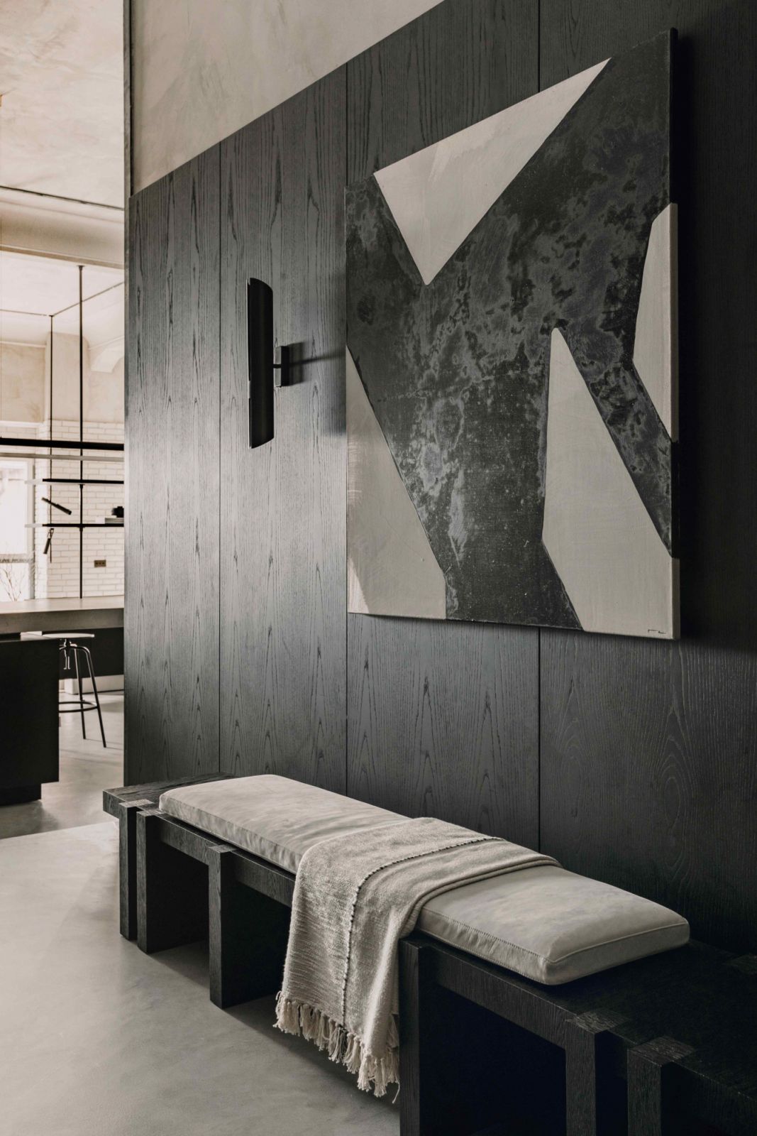 The entryway with dark timber-pannelled walls