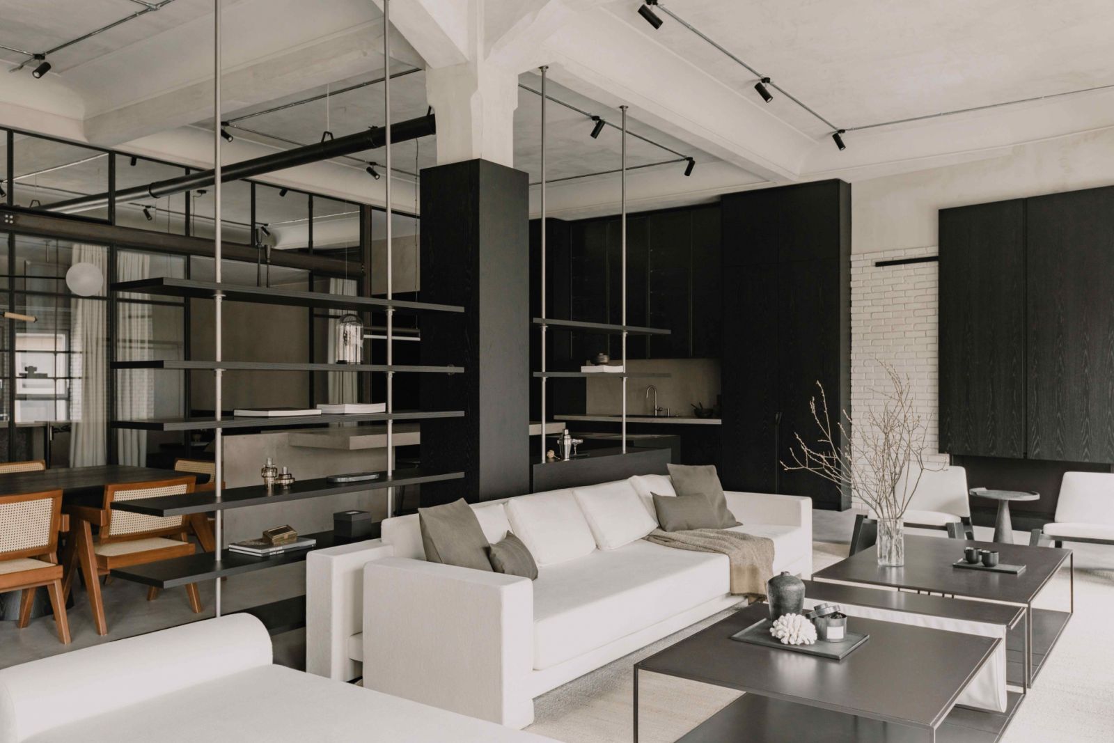 Shelving units divide the open-plan space into discrete areas