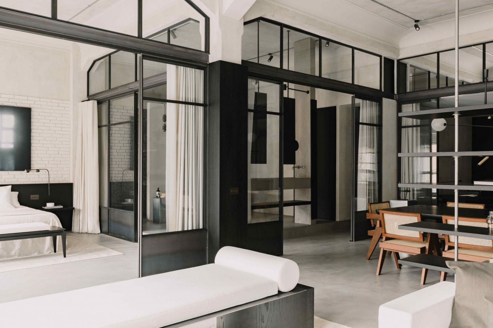 The glazed partitions act as a glass box, allowing natural light to permeate the apartment