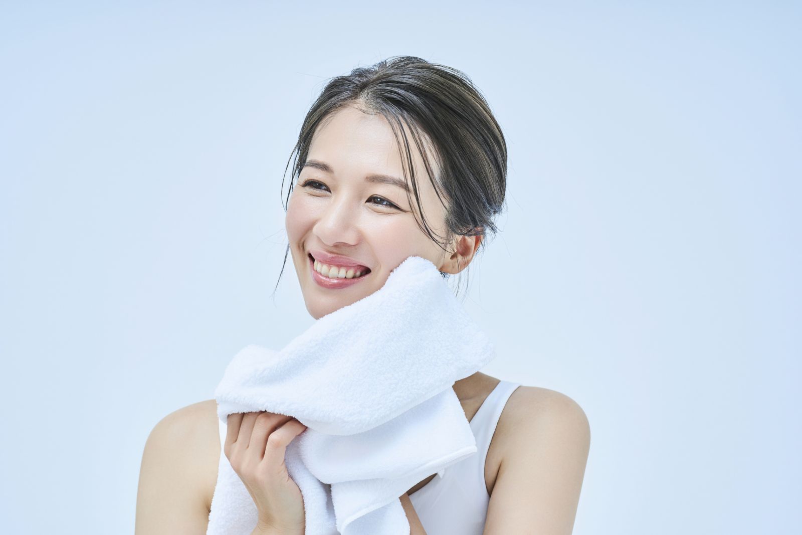 woman wiping her face with a towel