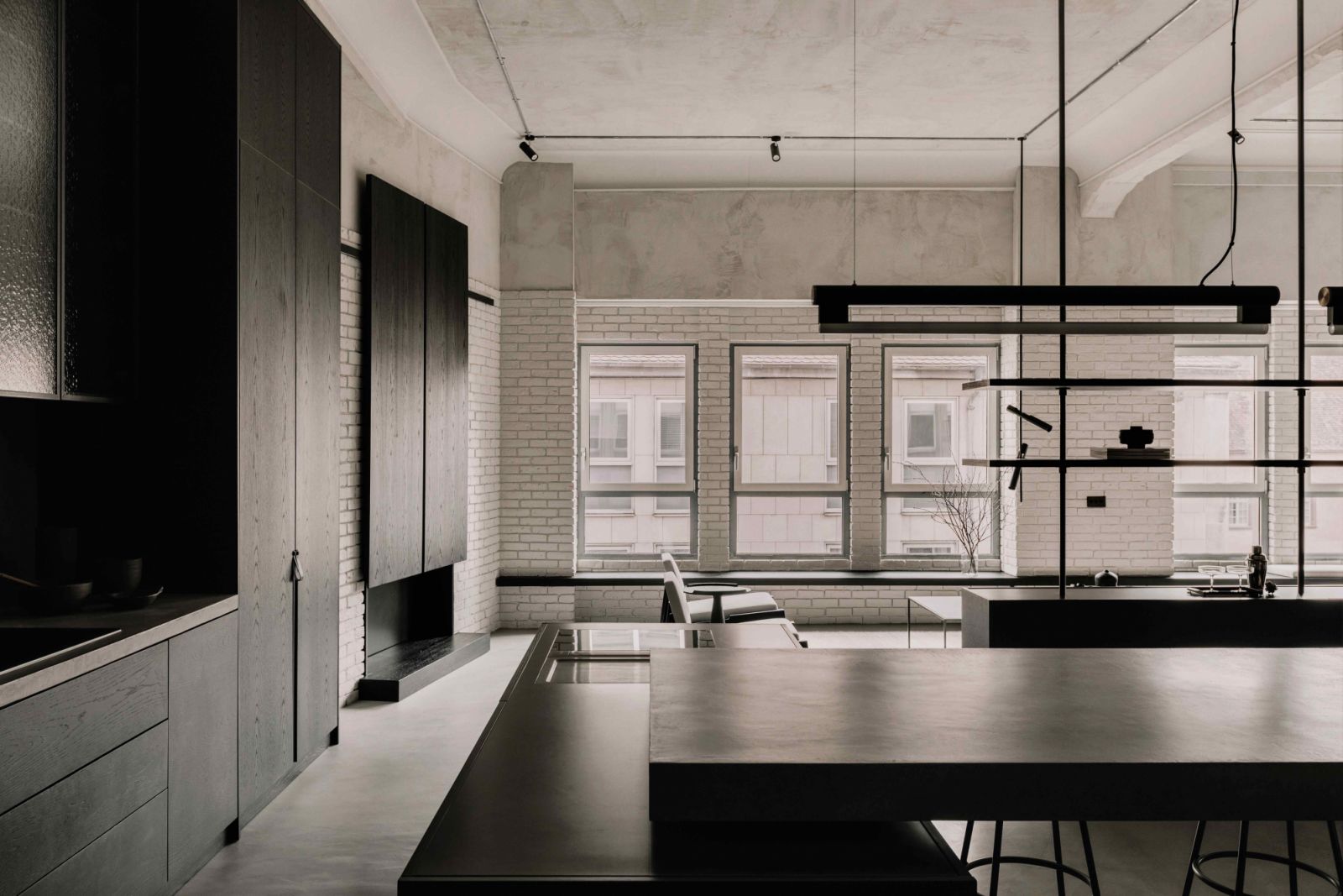 The black stained timber juxtaposes the white gypsum wall finishes in the background