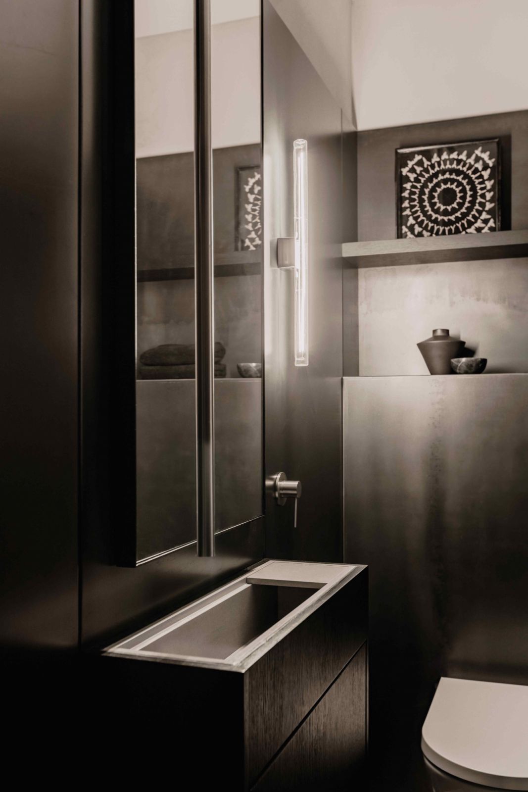 The powder room with vintage ceramic vase and marble bowl